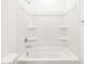 Clean, white bathtub with shower and built-in shelves for storage and convenience at 3557 E Audrey Dr, San Tan Valley, AZ 85143