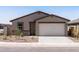 Attractive single-story house featuring a two-car garage and desert landscaping on a sunny day at 3557 E Audrey Dr, San Tan Valley, AZ 85143