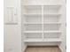 This walk-in pantry boasts tiled floors, white walls, and plenty of shelving for storage at 3557 E Audrey Dr, San Tan Valley, AZ 85143