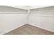 Walk-in closet with carpeted floor and metal hanging rods and shelving for optimal organization at 3557 E Audrey Dr, San Tan Valley, AZ 85143