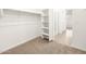 Carpeted walk-in closet with built-in shelving and views into the Primary bathroom and bedroom beyond at 3557 E Audrey Dr, San Tan Valley, AZ 85143