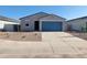 Single-story home showcasing a blue garage door, efficient landscaping, and a well-maintained front yard at 3660 E Audrey Dr, San Tan Valley, AZ 85143