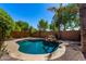Private backyard pool with mature trees and rock features, great for entertaining and relaxation at 41598 N Ranch Dr, San Tan Valley, AZ 85140