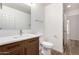 Powder bathroom featuring dark wood vanity with white countertop, toilet, and neutral walls at 41598 N Ranch Dr, San Tan Valley, AZ 85140