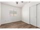 Bedroom with wood-look floors, a closet, neutral walls, a ceiling fan, and natural light at 41598 N Ranch Dr, San Tan Valley, AZ 85140