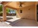 Covered patio featuring a ceiling fan, with views of the inviting backyard pool and landscaping at 41598 N Ranch Dr, San Tan Valley, AZ 85140