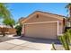 Beige garage door highlighting the exterior of this single-story home, complemented by desert landscaping at 41598 N Ranch Dr, San Tan Valley, AZ 85140