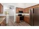 Well-equipped kitchen with stainless steel appliances, wood cabinets, and wood-look flooring at 41598 N Ranch Dr, San Tan Valley, AZ 85140