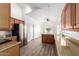 Modern kitchen features stainless steel appliances, granite countertops, and wood-look flooring at 41598 N Ranch Dr, San Tan Valley, AZ 85140