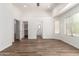 Bright main bedroom featuring neutral walls, wood-look flooring, and natural light from a window at 41598 N Ranch Dr, San Tan Valley, AZ 85140