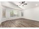 Bright main bedroom featuring wood-look floors, multiple windows and neutral walls at 41598 N Ranch Dr, San Tan Valley, AZ 85140