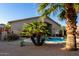 Backyard pool with palm trees and view of the home at 41847 W Sparks Ct, Maricopa, AZ 85138