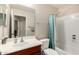 Cozy bathroom featuring a wooden vanity, white sink, and a shower with a blue curtain at 41847 W Sparks Ct, Maricopa, AZ 85138