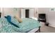 Comfortable bedroom with neutral walls, TV, ensuite bath, and plenty of sunlight at 41847 W Sparks Ct, Maricopa, AZ 85138