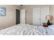 Spacious bedroom with an open doorway and closet, painted in neutral colors at 41847 W Sparks Ct, Maricopa, AZ 85138