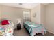 Bright bedroom featuring two beds, a window with blinds, and warm-toned walls at 41847 W Sparks Ct, Maricopa, AZ 85138