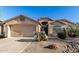 Charming single-story home featuring desert landscaping and a two-car garage with a neutral color palette at 41847 W Sparks Ct, Maricopa, AZ 85138