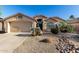 Charming single-story home featuring desert landscaping and a two-car garage with a neutral color palette at 41847 W Sparks Ct, Maricopa, AZ 85138