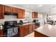 Kitchen featuring wood cabinets, modern appliances, a double stainless steel sink, and a breakfast nook at 41847 W Sparks Ct, Maricopa, AZ 85138