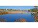 Beautiful lake view showcasing the community's golf course and surrounding homes, creating a serene and inviting atmosphere at 41847 W Sparks Ct, Maricopa, AZ 85138