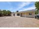 Spacious backyard featuring stone ground cover, partial patio cover, and ample room for entertaining at 4307 E Walatowa St, Phoenix, AZ 85044