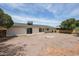Spacious backyard with rock ground cover, covered patio, and mature trees on a sunny day at 4307 E Walatowa St, Phoenix, AZ 85044