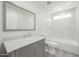 Updated bathroom with large vanity, framed mirror, and bathtub/shower with white tile surround at 4307 E Walatowa St, Phoenix, AZ 85044