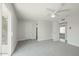 Neutral bedroom features gray carpet, modern ceiling fan, and exits to multiple rooms at 4307 E Walatowa St, Phoenix, AZ 85044