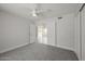 Spacious bedroom with ceiling fan and neutral gray walls with doorway leading to another room at 4307 E Walatowa St, Phoenix, AZ 85044