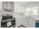 Close-up of a well-lit kitchen showcasing stainless steel appliances, quartz countertops, and white cabinetry at 4307 E Walatowa St, Phoenix, AZ 85044