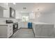Modern kitchen featuring white cabinets, stainless steel appliances, and a large quartz countertop island at 4307 E Walatowa St, Phoenix, AZ 85044
