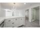 Corner view of kitchen island that is open to living area and shows a modern lighting fixture at 4307 E Walatowa St, Phoenix, AZ 85044
