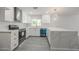 Modern kitchen featuring white cabinets, stainless steel appliances, and a large quartz countertop island at 4307 E Walatowa St, Phoenix, AZ 85044