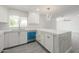 Bright kitchen with white cabinets, quartz countertops, a stainless steel sink, and modern lighting fixture at 4307 E Walatowa St, Phoenix, AZ 85044