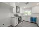 Bright kitchen features white cabinets, stainless steel appliances and modern tile flooring at 4307 E Walatowa St, Phoenix, AZ 85044