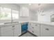 Close-up of a well-lit kitchen showcasing stainless steel sink, quartz countertops, and white cabinetry at 4307 E Walatowa St, Phoenix, AZ 85044