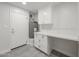 Bright laundry room features modern cabinets, ample counter space, and gray tile floors at 4307 E Walatowa St, Phoenix, AZ 85044