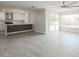 Open-concept living space with kitchen in the background featuring white cabinets and quartz countertops at 4307 E Walatowa St, Phoenix, AZ 85044