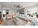 Bright living room featuring rattan furniture, neutral colors, and a ceiling fan at 4307 E Walatowa St, Phoenix, AZ 85044