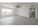 Bright living room with wood-look tile floors, recessed lighting, and hallway leading to bathroom at 4307 E Walatowa St, Phoenix, AZ 85044