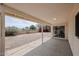 Covered patio overlooking a spacious backyard with gravel landscaping and mature trees at 4307 E Walatowa St, Phoenix, AZ 85044