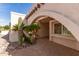 Close-up of archway entrance featuring desert landscaping and textured stucco walls at 4527 E Sunrise Dr, Phoenix, AZ 85044