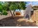 Backyard with a tree, partial fence, and gravel at 4527 E Sunrise Dr, Phoenix, AZ 85044