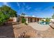 Inviting backyard featuring a sparkling pool, covered patio, and mature landscaping at 4527 E Sunrise Dr, Phoenix, AZ 85044