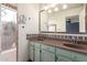 Bathroom featuring dual sinks, decorative tile, and an oversized mirror at 4527 E Sunrise Dr, Phoenix, AZ 85044