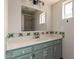 Bathroom features tile countertop and cabinetry with neutral fixtures and includes a large mirror and additional above lighting at 4527 E Sunrise Dr, Phoenix, AZ 85044