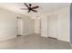 Bedroom with ceiling fan, closet, and windows providing natural light at 4527 E Sunrise Dr, Phoenix, AZ 85044