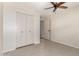 Bedroom with a neutral color scheme features a spacious closet for storage and a ceiling fan for efficient cooling at 4527 E Sunrise Dr, Phoenix, AZ 85044