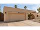 Attached two-car garage with desert landscaping and an archway entrance to the single-story home at 4527 E Sunrise Dr, Phoenix, AZ 85044