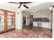 Open kitchen and sunroom layout with Saltillo tile and stainless steel appliances at 4527 E Sunrise Dr, Phoenix, AZ 85044
